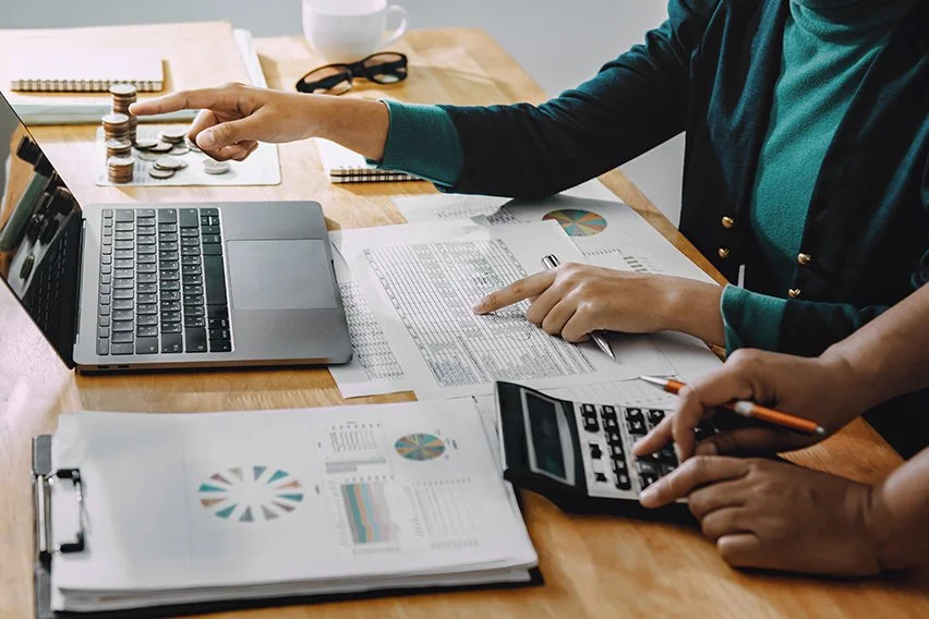 People working on accounts receivable, desk view